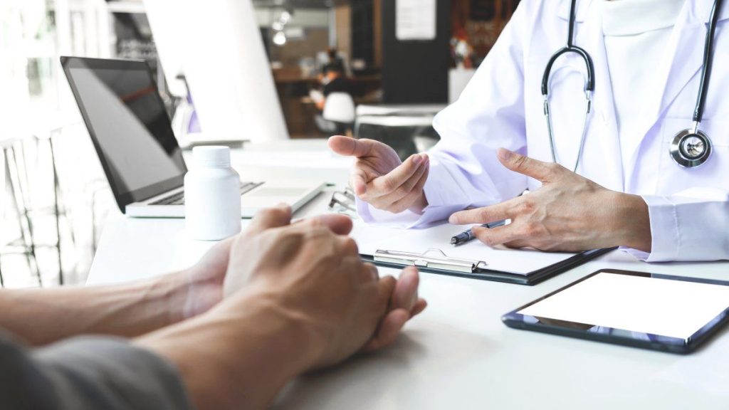 doctor reaching out to patients hand