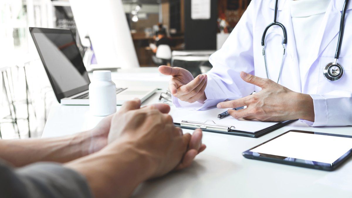 doctor reaching out to patients hand