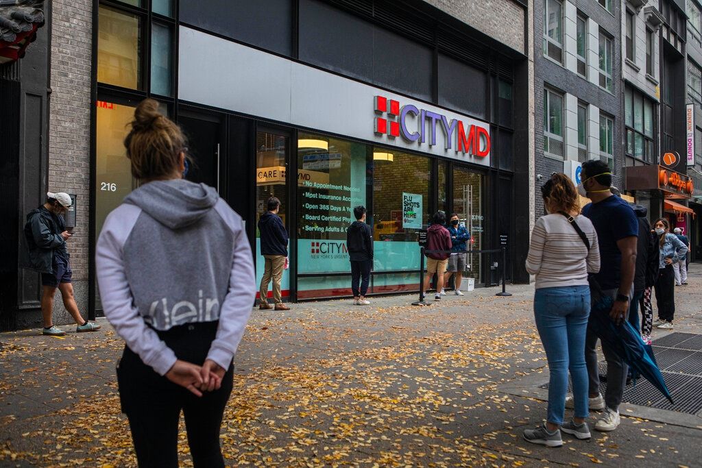 people waiting in line outside of a citymd