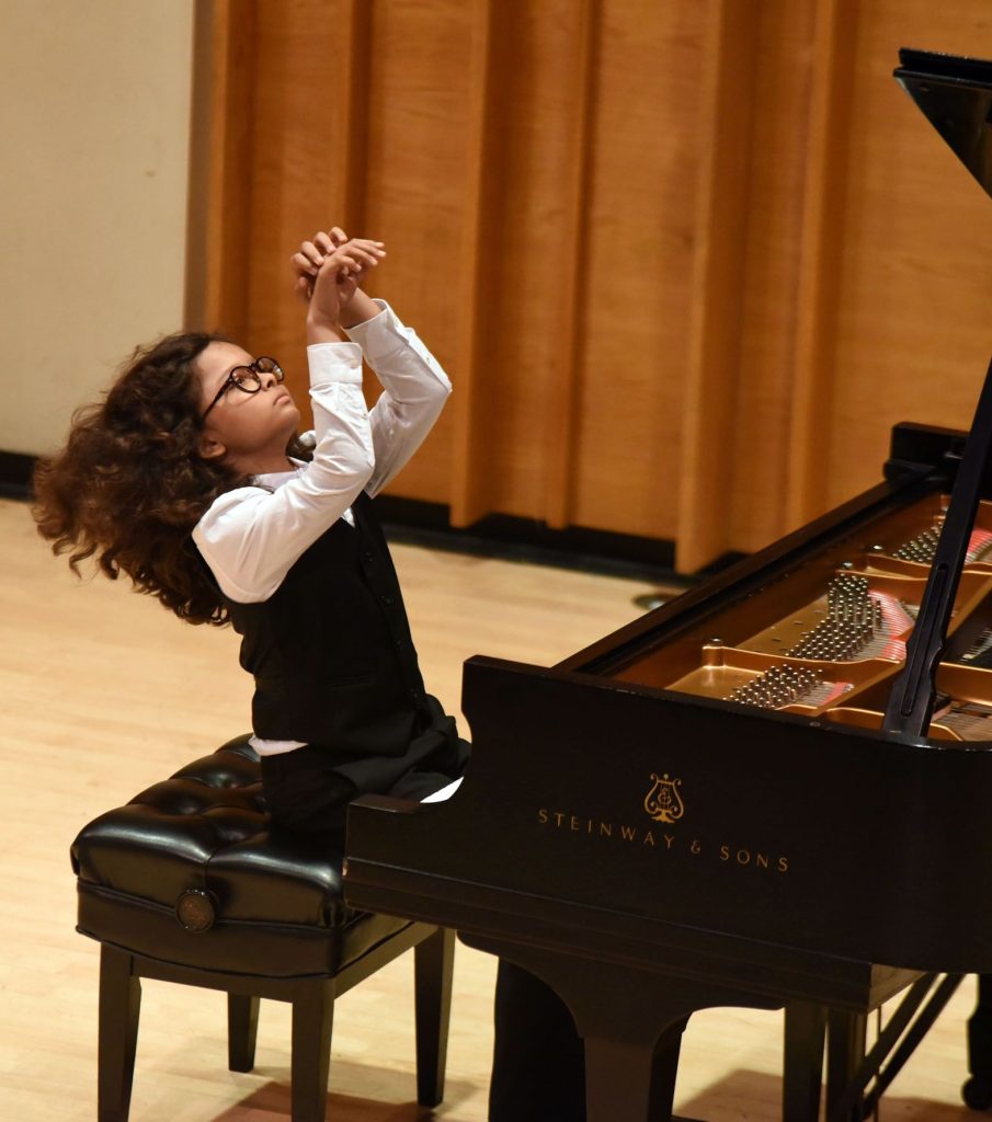young boy playing piano