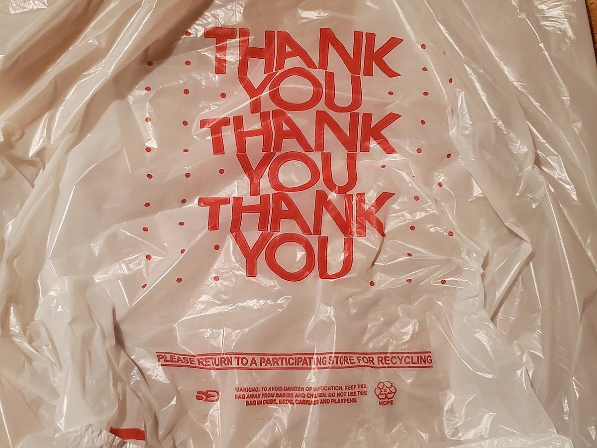 plastic bag with the words THANK YOU printed on it in a repeating pattern