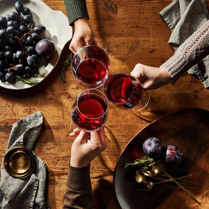 people cheering glasses of wine