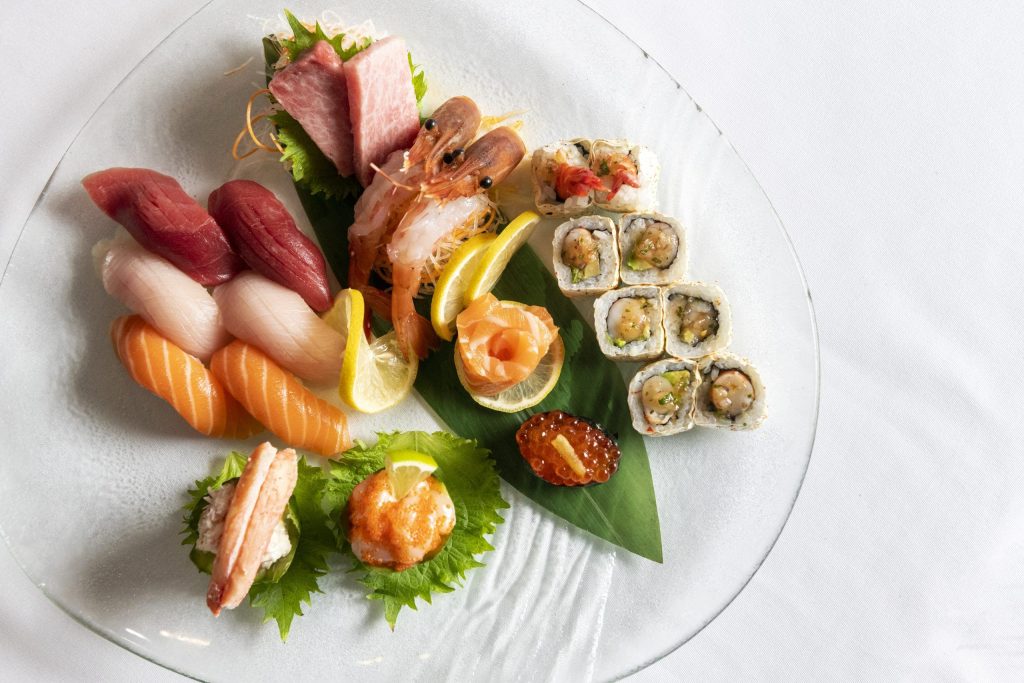 various sushi rolls and pieces of sashimi arranged on a plate from Atlantic Grill