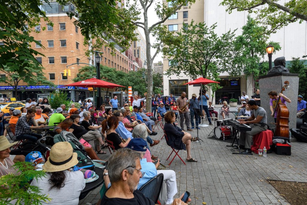 parkgoers enjoy free music in Richard Tucker Park in the summer