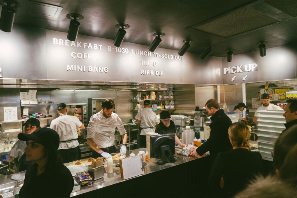 lunchgoers grab food from a busy Bang Bar counter in The Shops at Columbus Circle