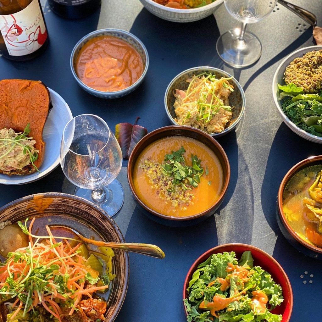 Thanksgiving dishes from Le Botaniste set up on a blue tablecloth
