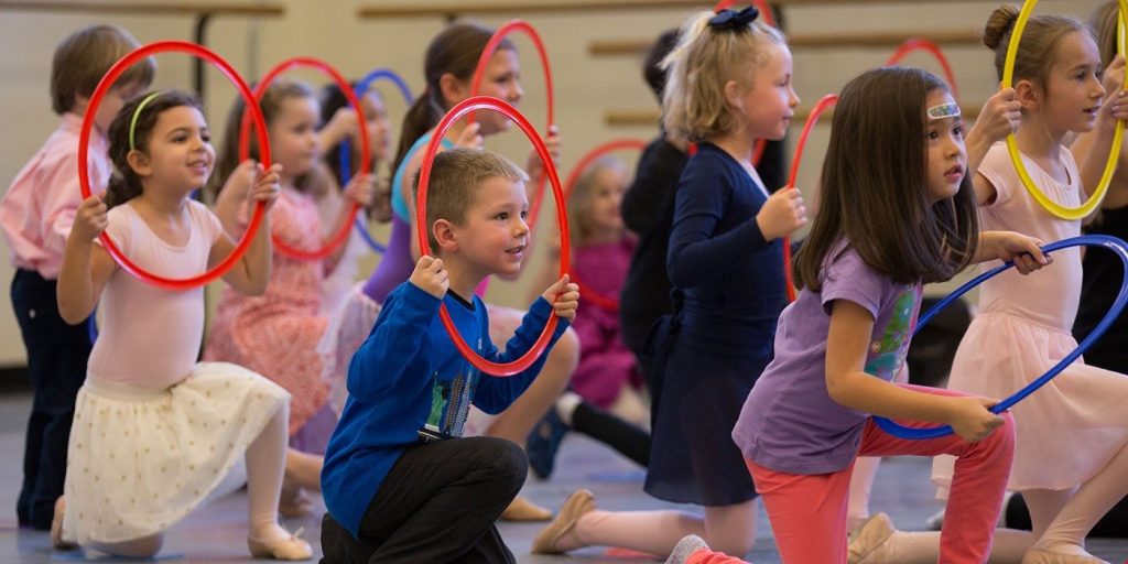 kids play with hula hoops at the NYC ballet