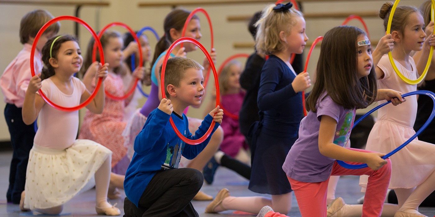 kids play with hula hoops at the NYC ballet