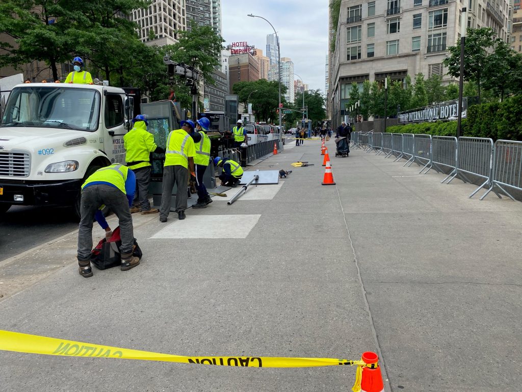 workers removing the citi bike station