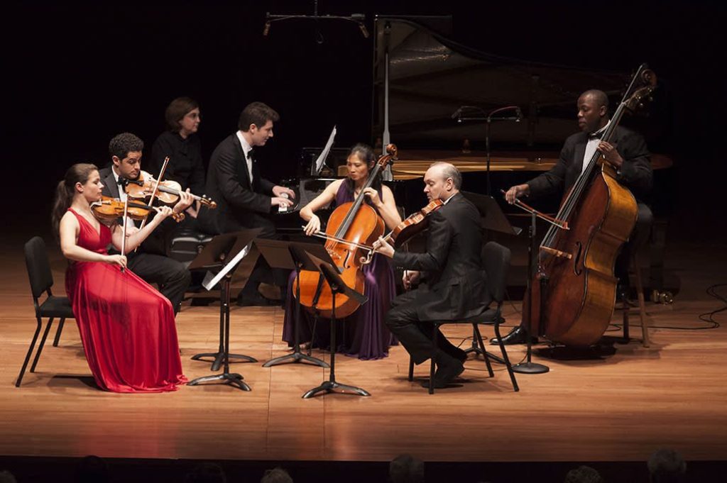musicians playing instruments on stage
