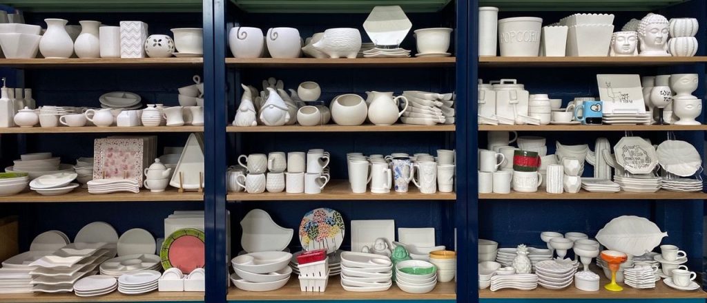 shelves of pottery waiting to be painted at Color Me Mine