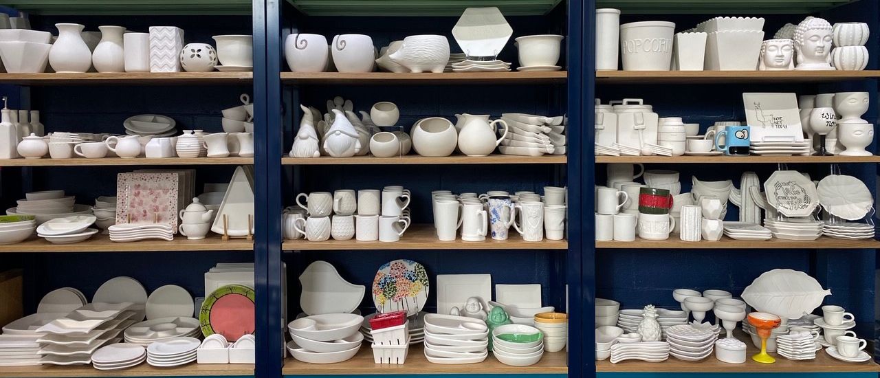 shelves of pottery waiting to be painted at Color Me Mine