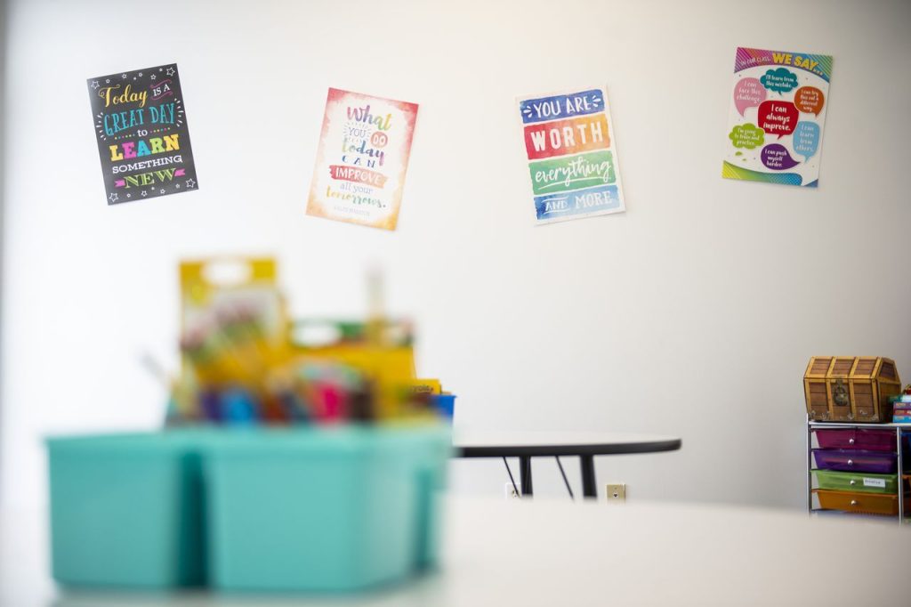 classroom space with tables and posters