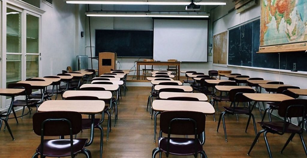 empty classroom with rows of desks