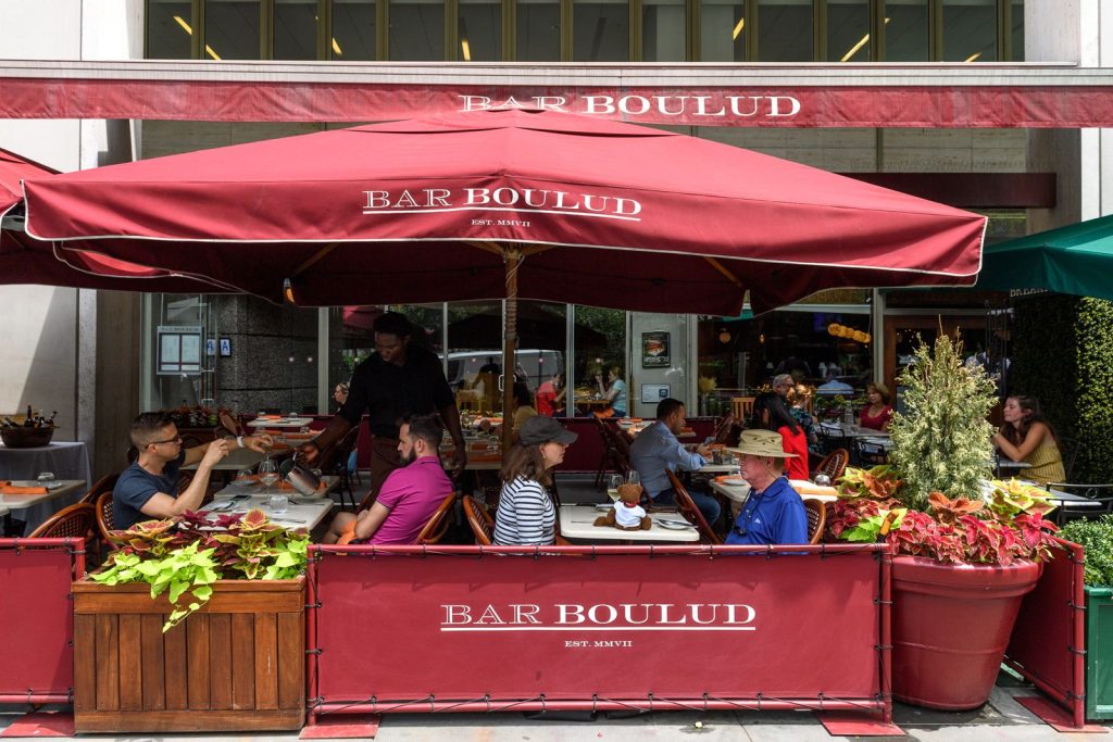 patrons enjoy outdoor seating at Bar Boulud on Broadway in the summer