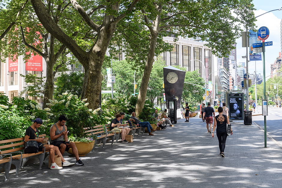 people walking and sitting in Dante Park