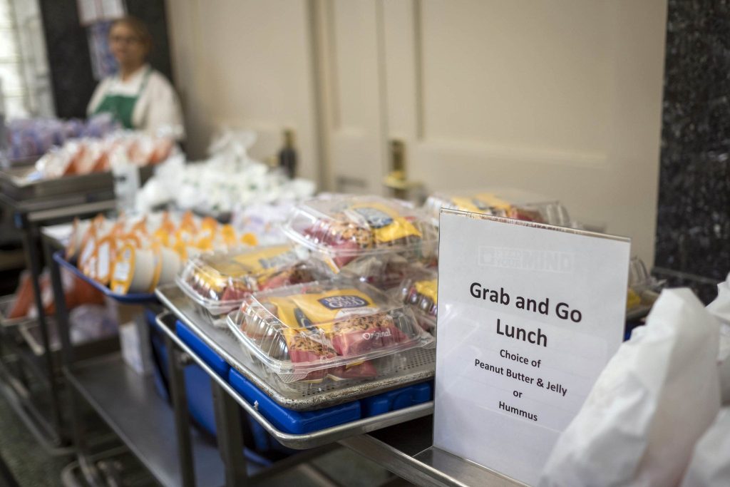 grab and go meals from DOE line up on a table ready to be handed out
