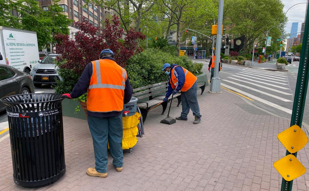 goddard green keeper sweep liter and collect trash from a Broadway Mall pedestrian landing