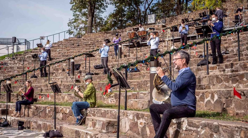 musicians playing instruments outside in holiday gear