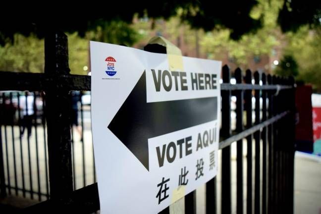 a sign pointing to a polling location