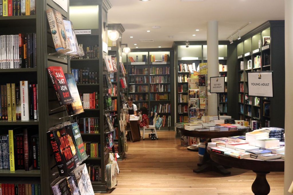 Inside of Shakespeare and Co with book filled shelves