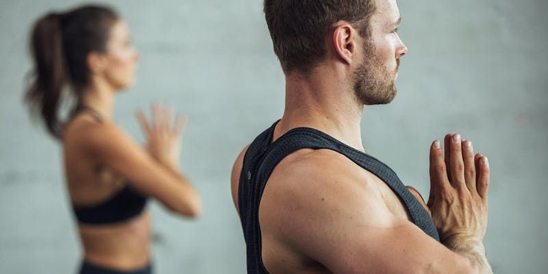 two people pose for yoga with their hands together