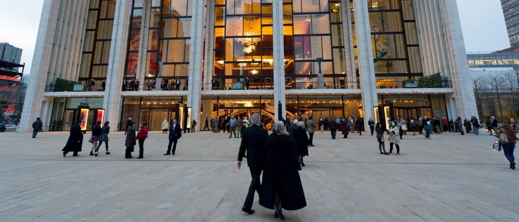 folks gather outside of the Met Opera in wintertime