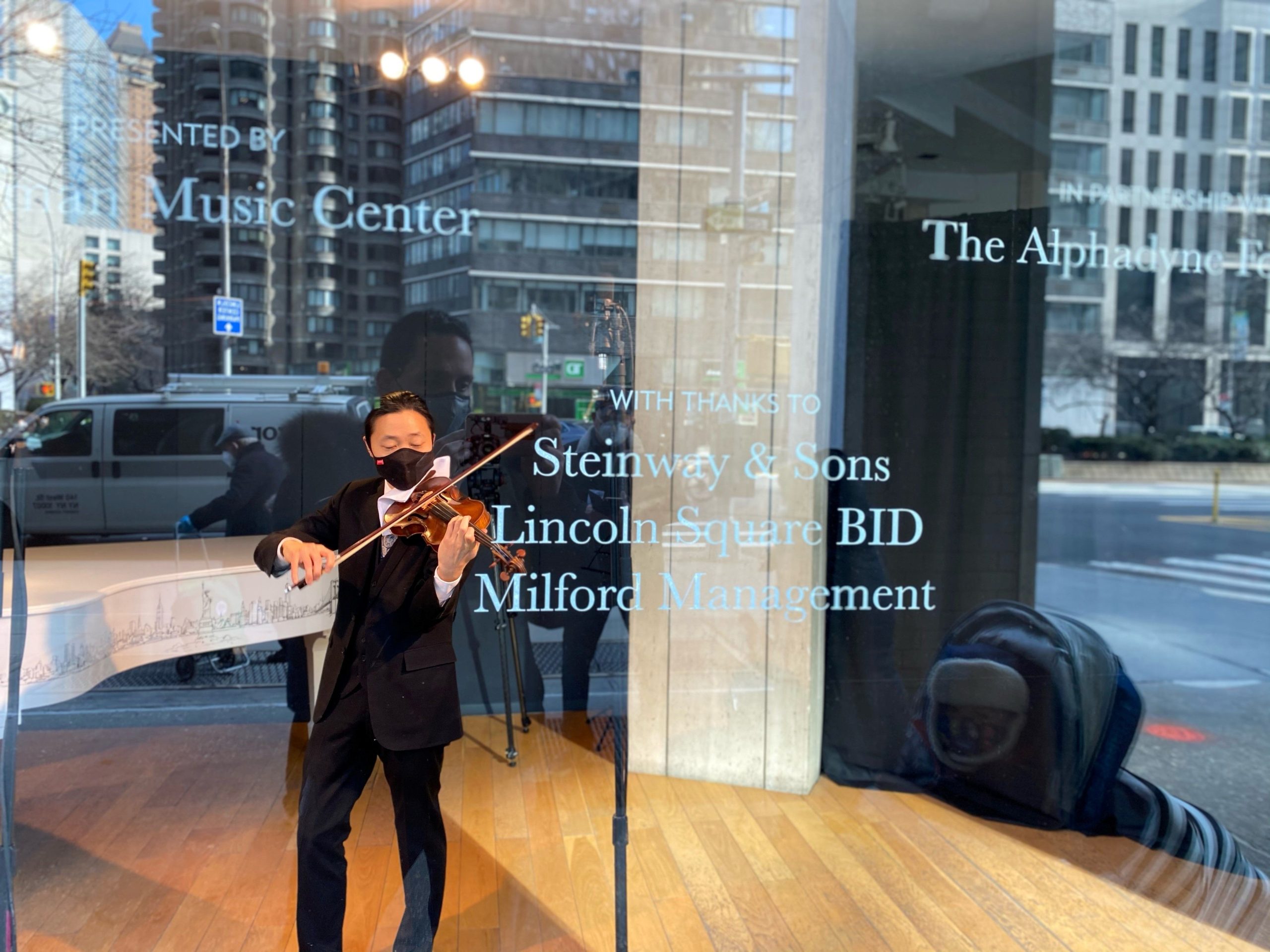 musician playing in a storefront