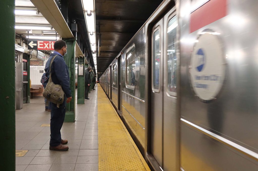 man waiting for subway train