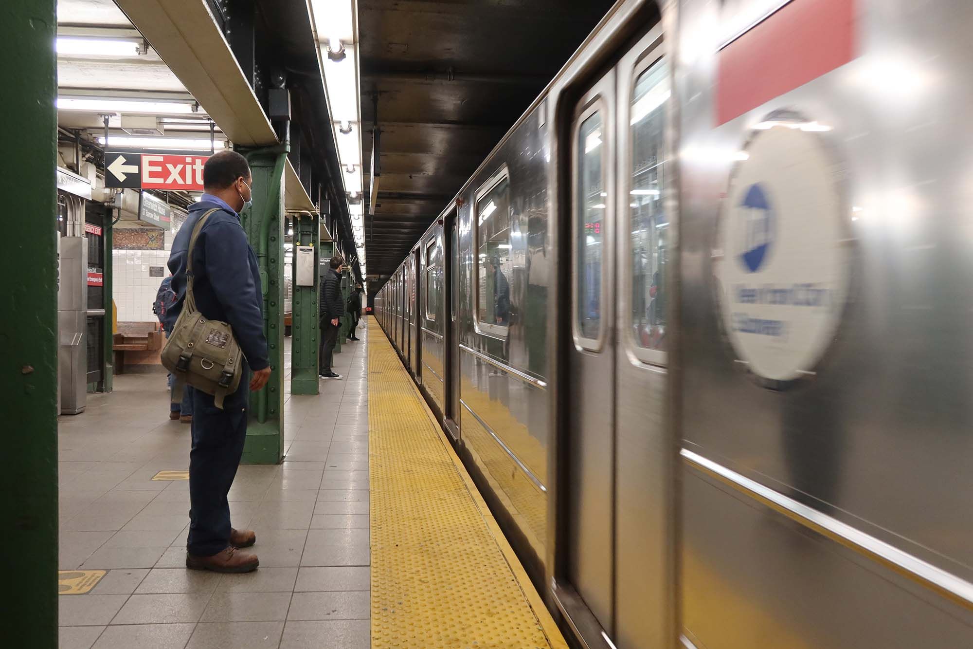 man waiting for subway train