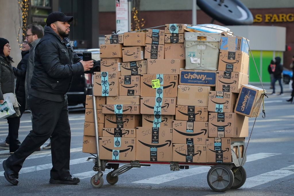 delivery man pushing a cart full of packages