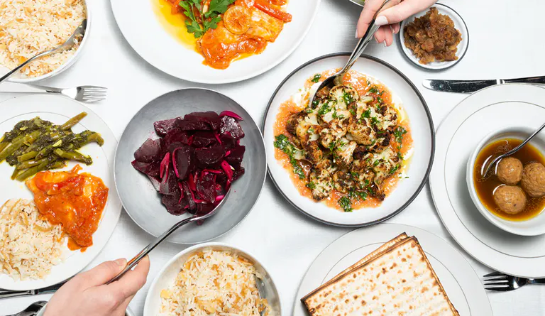 a table of foods from Breads Bakery's Passover Seder Meal for order