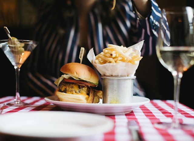mini slider with fries on a classic PJ Clarke's table cloth next to a dirty martini