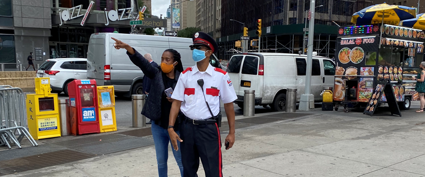 public safety officer helping a pedestrian with directions