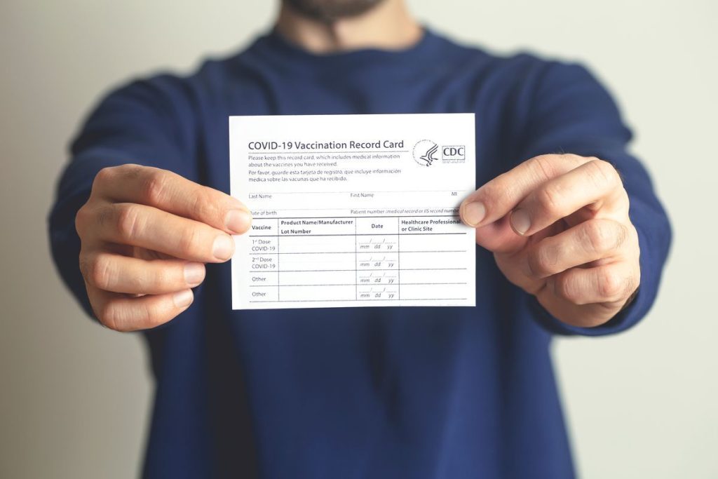 person holding vaccine card