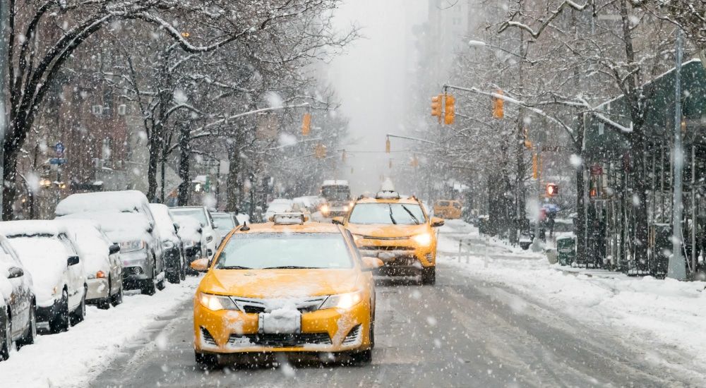Taxis driving through NYC in the snow