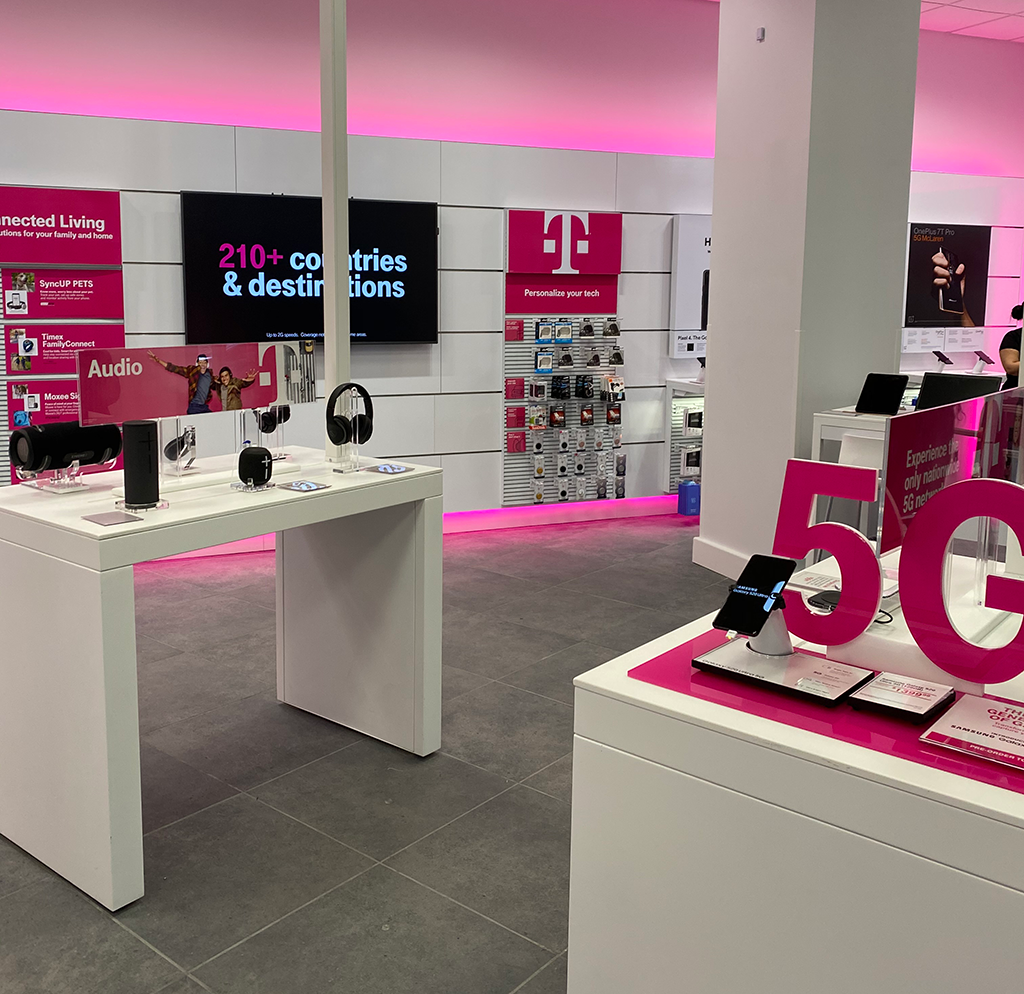 The inside of TMobile with pink walls and cell phone displays