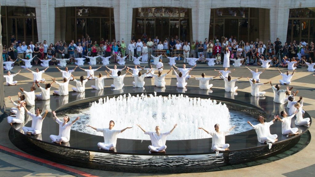 dancers sitting in a circle on lincoln center plaza