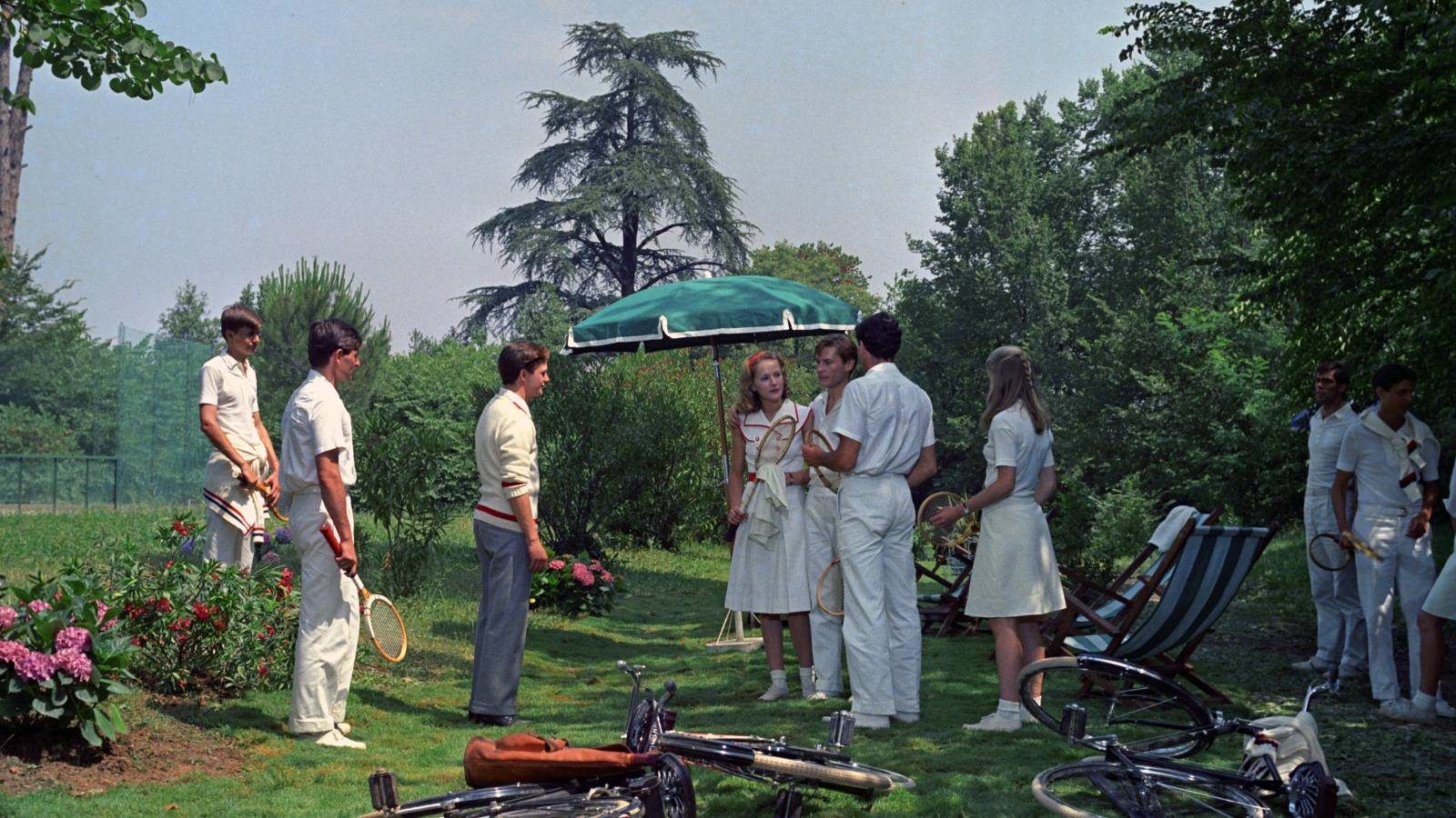 still from The Garden of the Finzi-Continis in which chatacters get ready to play a game of croquette in the summertime