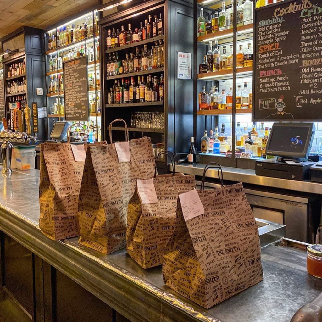 bags for take out line the counter of The Smith in Lincoln Square