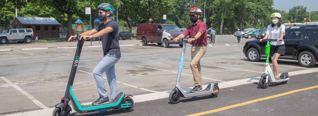 people riding e-scooters