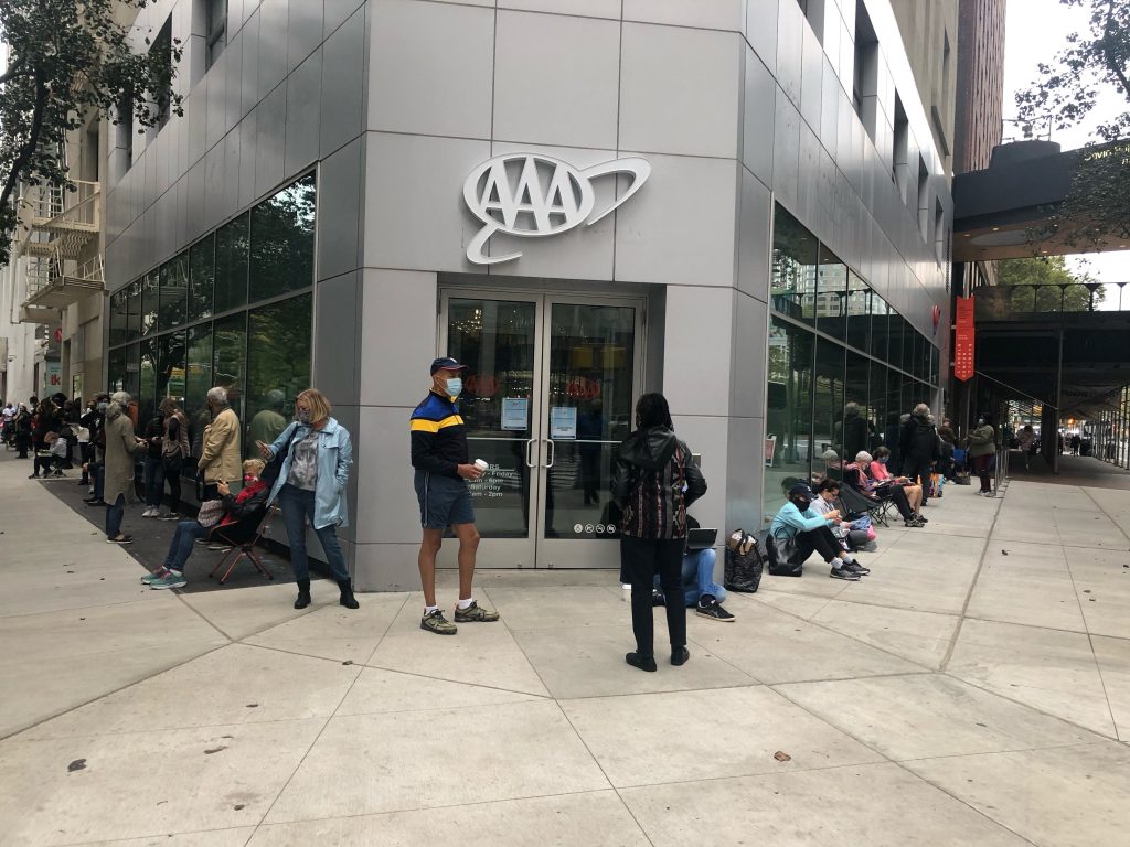 people standing outside david rubenstein atrium waiting to vote