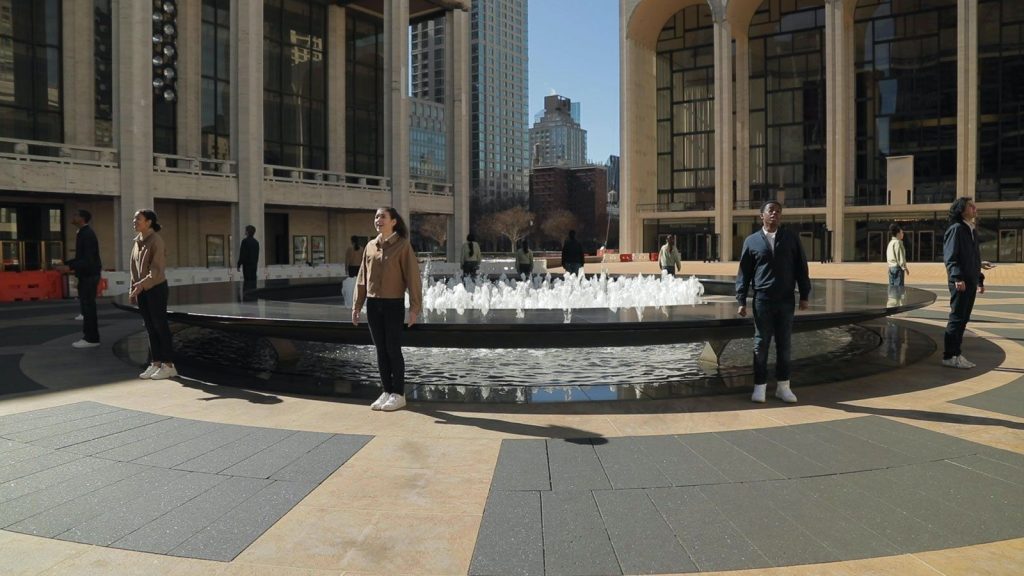 young people's chorus performing around the lincoln center fountain