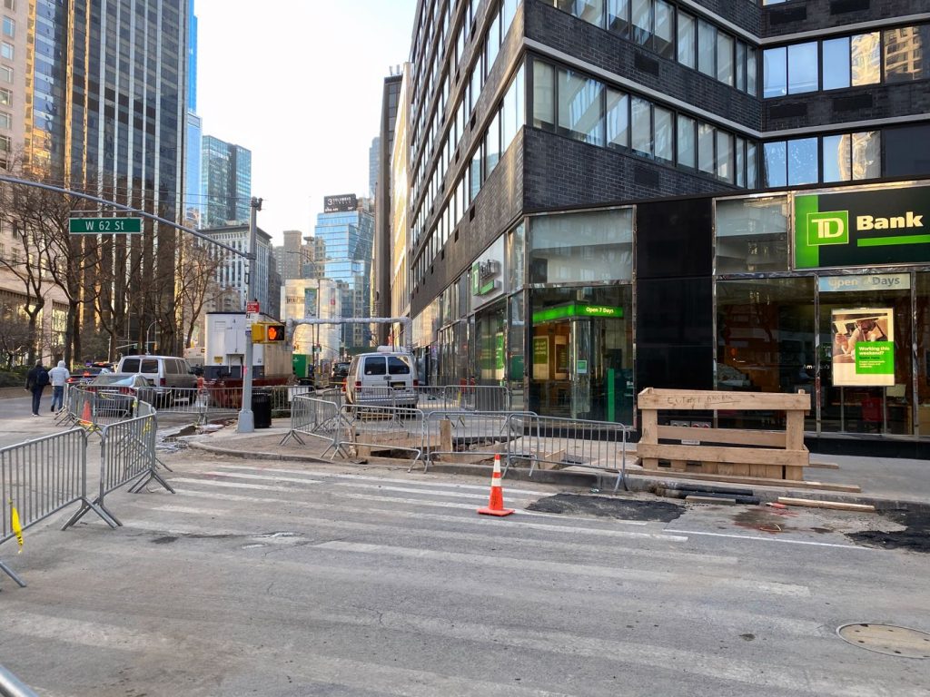 photo looking down the Bway sidewalk from west 62nd street with many barricades and additional construction