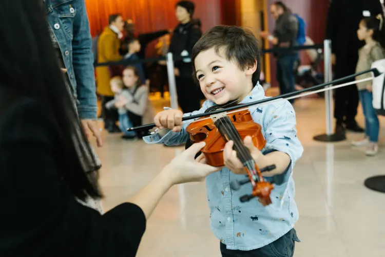 Photo of a young boy playing a violin