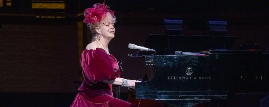 Photo of a woman in a red dress playing a piano