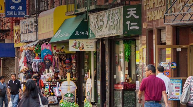 Photo of many storefronts on a busy city street