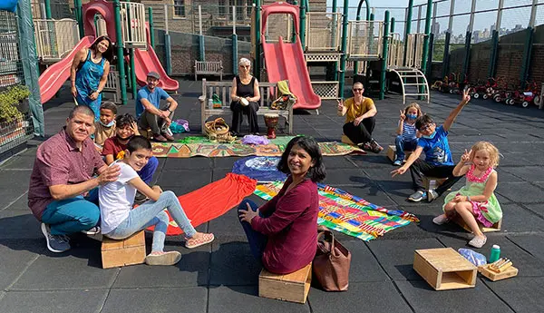 Photo of a group of families sitting in a circle