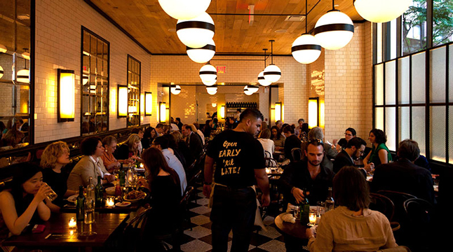 Photo of a waiter in a busy restaurant