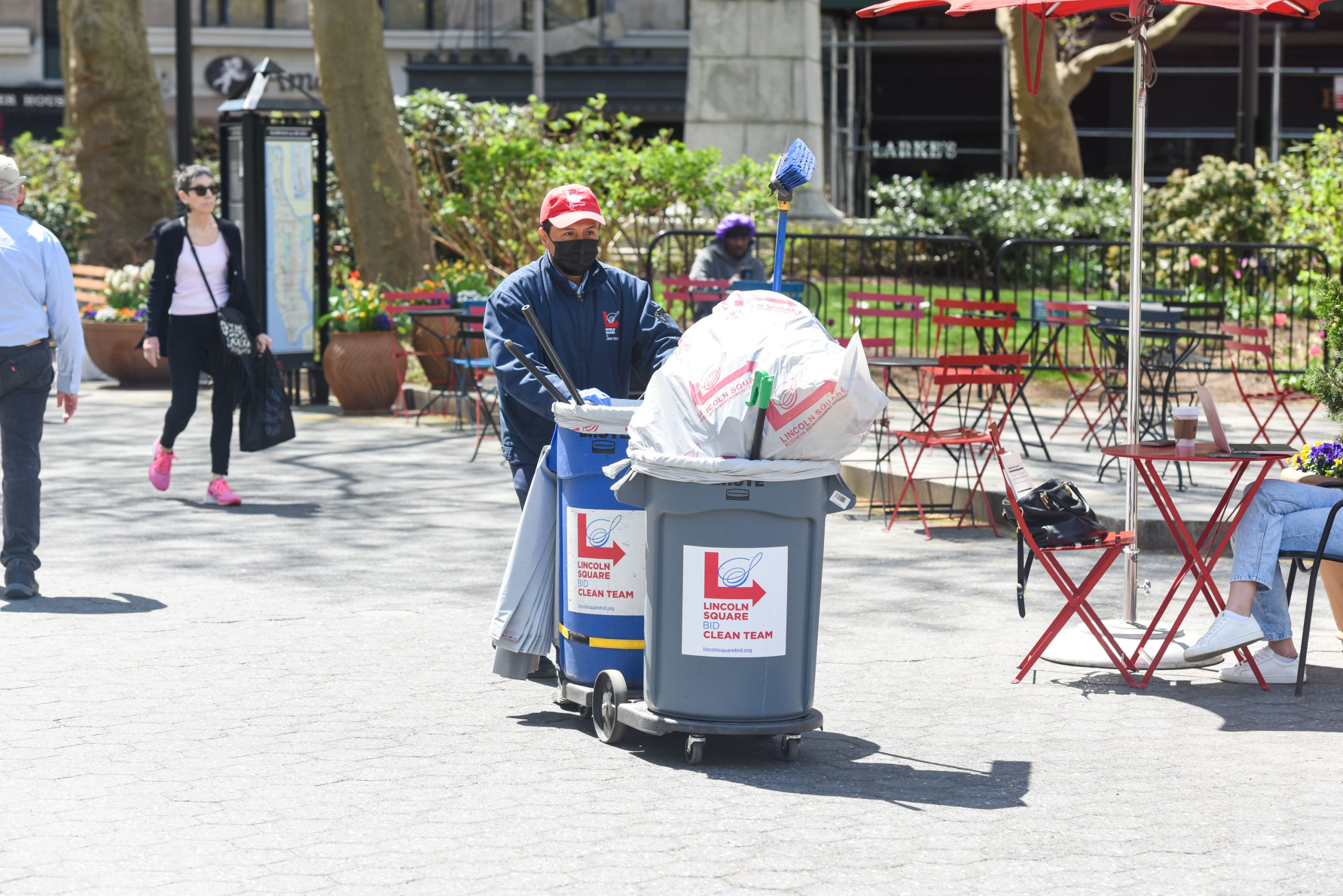 A Clean Team member pushing a cart full of public litter